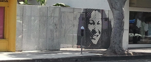 self portrait painted on 8 foot tall studio fence
